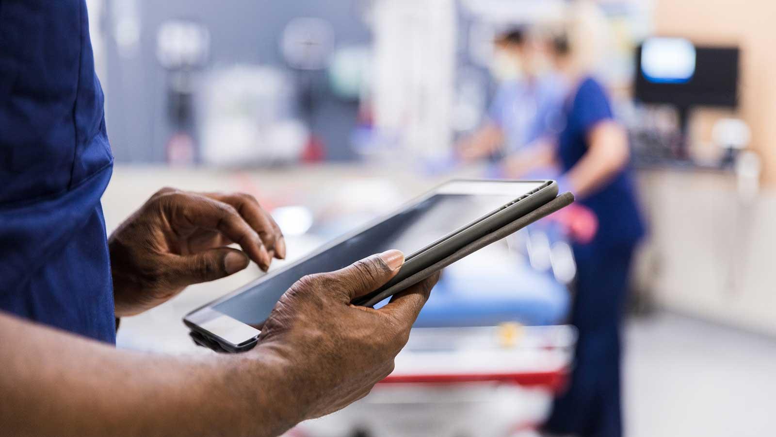 Individual using an iPad in a medical setting